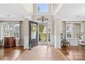 Bright foyer features tile flooring, large windows and an open doorway with decorative wreath at 112 Saye Pl, Mooresville, NC 28115