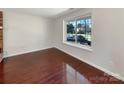 Bright bedroom with hardwood floors and a large window offering natural light at 11712 Battery Pl, Charlotte, NC 28273