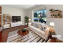 Stylish living room featuring a large window, modern furniture, and decorative shelving at 11712 Battery Pl, Charlotte, NC 28273