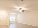 Bright living room with modern ceiling fan, neutral walls, and light-colored flooring at 2009 Amos Oaks Ln, Charlotte, NC 28215