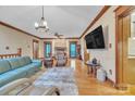 Open living room with hardwood floors, stone fireplace, and natural lighting at 298 Poplar Grove Ct, Taylorsville, NC 28681