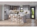 Modern gray kitchen featuring stainless steel appliances, a marble countertop island, and a stylish pendant lighting at 309 Yaupon Ct, Fort Mill, SC 29708