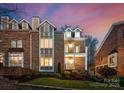 Beautiful brick townhome with dormer windows, private balcony, and professionally landscaped yard at 415 Spring St, Davidson, NC 28036