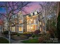 Charming brick townhome with landscaped front yard, dormer windows and cozy balcony at 415 Spring St, Davidson, NC 28036