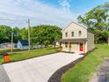 Well-maintained two-story house featuring a long driveway, green lawn, and complemented by mature trees at 570 Key West Ave, Kannapolis, NC 28081