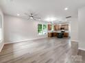 Spacious, light-filled living room with modern ceiling fan, neutral walls, and durable wood-look floors at 570 Key West Ave, Kannapolis, NC 28081