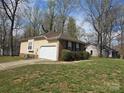 Spacious home featuring a large garage, beautiful lawn, and additional outbuilding at 8411 Rhian Brook Ln, Charlotte, NC 28216