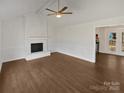 Open living room boasts hardwood floors and a brick fireplace, perfect for entertaining at 10707 Copper Field Dr, Pineville, NC 28134