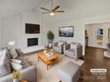 Bright living room offers a cozy fireplace, ample seating, and modern decor at 10707 Copper Field Dr, Pineville, NC 28134