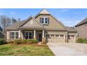 Charming two-story home featuring a three car garage, stone accents, and well-maintained landscaping at 11037 Thornbeck Ln, Midland, NC 28107