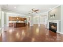 Open-concept living space includes a modern kitchen, hardwood floors, fireplace, and adjoining rooms at 11037 Thornbeck Ln, Midland, NC 28107