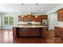 Well-equipped kitchen with granite counters, stainless appliances, and a center island at 11037 Thornbeck Ln, Midland, NC 28107