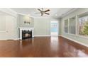 Spacious living room featuring hardwood floors, a cozy fireplace, and bright windows at 11037 Thornbeck Ln, Midland, NC 28107
