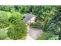 Aerial view of a home with a driveway, garage, and surrounded by mature trees at 3004 Vernell Ln, Shelby, NC 28150