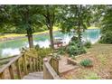 Beautiful view of a waterfront dock with boats and seating, accessible by stairs at 3004 Vernell Ln, Shelby, NC 28150