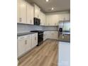 Beautiful kitchen featuring stainless appliances, modern cabinets, and light wood floors providing an ideal cooking space at 313 Knotty Wood Dr # 79, Monroe, NC 28110
