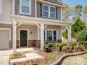 Close-up of a welcoming front porch, adorned with stone accents and a decorative wreath at 8137 Bryson Rd, Fort Mill, SC 29707