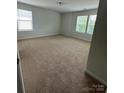Spacious carpeted bedroom with natural light from double windows at 8232 Waxhaw Hwy, Waxhaw, NC 29173
