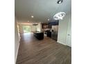 Open kitchen with dark cabinets, stainless steel appliances, island, and modern lighting fixtures at 8232 Waxhaw Hwy, Waxhaw, NC 29173