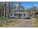 Charming one-story home with front porch, black shutters, and a driveway on a sunny day at 1034 Marietta St, Charlotte, NC 28214
