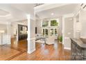 Bright living room with soaring ceilings, hardwood floors, and large windows for abundant natural light and elegant ambiance at 10602 Country Squire Ct, Matthews, NC 28105