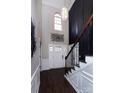 Open foyer with soaring ceilings, dark floors, designer lighting, and large windows providing lots of natural light at 10928 Jardin Way, Charlotte, NC 28215