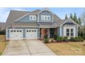 Beautiful two-story home featuring a two-car garage, well-manicured lawn, and lovely curb appeal at 12619 Old Westbury Dr, Cornelius, NC 28031