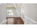 Bright foyer features hardwood floors, natural light from window and white door, and classic paneled trim at 134 Asmodean Ln, Troutman, NC 28166