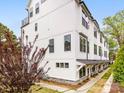 Stylish white townhouse complex with modern design elements and well-manicured lawns, offering a sophisticated living experience at 1413 Kenilworth Ave, Charlotte, NC 28203