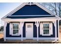 Attractive blue home with a white trim, decorative white post, and a pristine white front door at 1432 Blackbird Dr, Clover, SC 29710