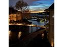 Night view of marina with glowing pier lights reflecting off the still water at 18009 Kings Point Dr # C, Cornelius, NC 28031