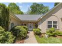 Inviting front entrance with a well-lit walkway surrounded by manicured bushes and trees at 2341 Shannon Dr, Belmont, NC 28012