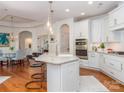 Modern kitchen with stainless steel appliances, a spacious island, and stylish pendant lighting at 2342 Wesley Landing Rd, Waxhaw, NC 28173