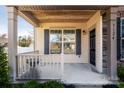 Inviting front porch featuring wood ceiling, a security camera, dark shutters and a grill at 3124 Berry Creek Rd, Charlotte, NC 28214