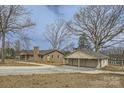 Exterior view of brick house and detached garage with a gravel driveway at 3225 Liberty Rd, Gold Hill, NC 28071
