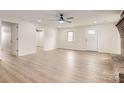 Bright living room with fireplace, ceiling fan, laminate floors and white walls at 3225 Liberty Rd, Gold Hill, NC 28071