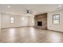 Spacious living room with a brick fireplace, ceiling fan and laminate floors at 3225 Liberty Rd, Gold Hill, NC 28071