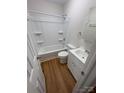 Clean bathroom with tub/shower combo, white vanity, updated fixtures, and wood-look flooring at 325 Orr Dr, Rock Hill, SC 29730
