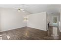Open living room featuring vaulted ceiling, neutral paint and modern ceiling fan at 3904 Crimson Wing Dr, Indian Trail, NC 28079