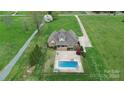 Expansive aerial view of the property, showcasing the home, pool, and surrounding landscape at 4205 New Town Rd, Waxhaw, NC 28173