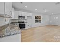 Open kitchen layout with stainless steel appliances, modern countertops, and natural light at 607 S 10Th St, Bessemer City, NC 28016