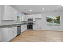 Modern kitchen with stainless steel appliances, granite countertops, and white cabinetry at 607 S 10Th St, Bessemer City, NC 28016
