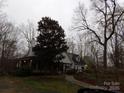 Charming exterior view of a two-story home with a covered porch and mature landscaping at 7218 Alexander Farm Rd, Monroe, NC 28110