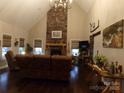 Inviting living room boasts a stone fireplace, vaulted ceilings, and hardwood floors at 7218 Alexander Farm Rd, Monroe, NC 28110