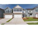 Charming new construction townhome with a two-car garage and beautifully landscaped front yard at 7865 Iron Rd, Sherrills Ford, NC 28673