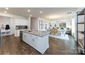 Spacious open-concept kitchen with a granite island, stainless steel appliances, and hardwood floors at 7871 Iron Rd, Sherrills Ford, NC 28673