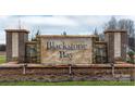 Blackstone Bay community entrance sign with brick pillars, stone accents, water features, and landscaping at 7871 Iron Rd, Sherrills Ford, NC 28673