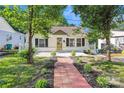 Beautiful home with manicured lawn, red brick walkway, and lovely landscaping at 813 North Ave, Charlotte, NC 28208