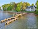 Aerial view of lakefront property with private dock and lush green surroundings at 8813 Graham Rd, Denver, NC 28037