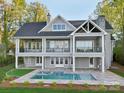 Backyard features a beautiful pool and spa with stone surround and lush landscaping at 8813 Graham Rd, Denver, NC 28037
